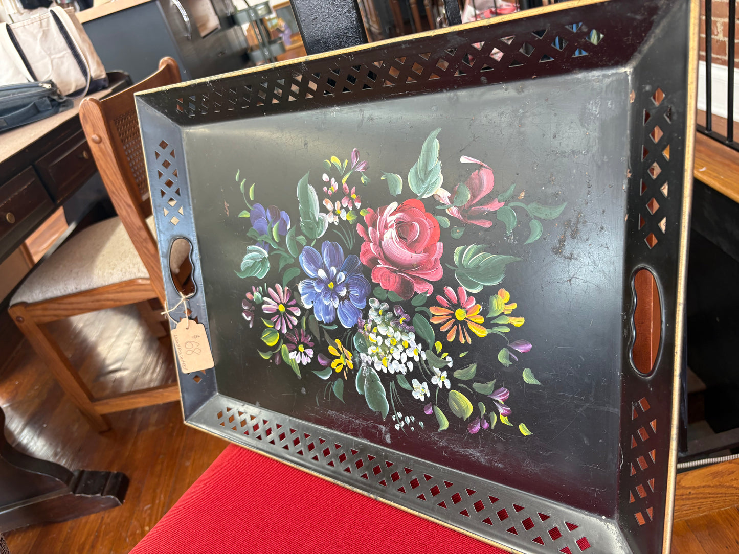 Decorative metal tray with floral design.