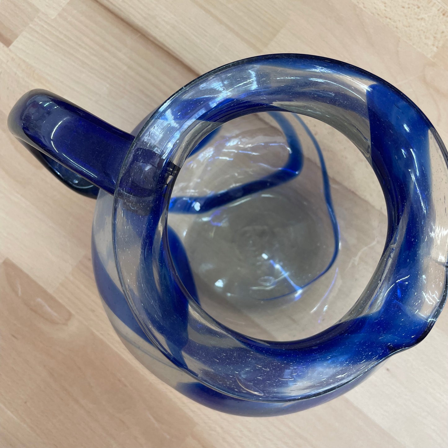 Hand Blown Mexican Glass Pitcher with Blue Swirl Design and Curved Handle