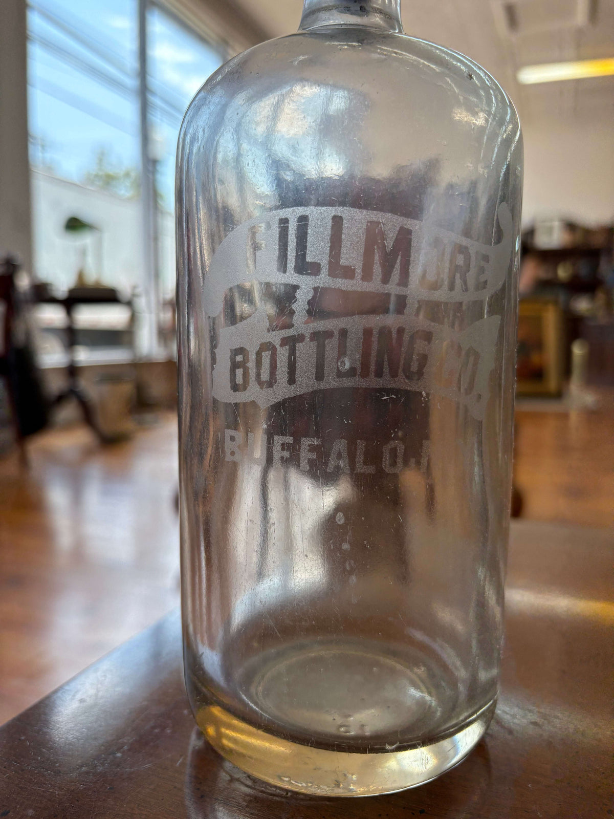 Fillmore Bottling Co. embossed glass bottle — Buffalo NY branding