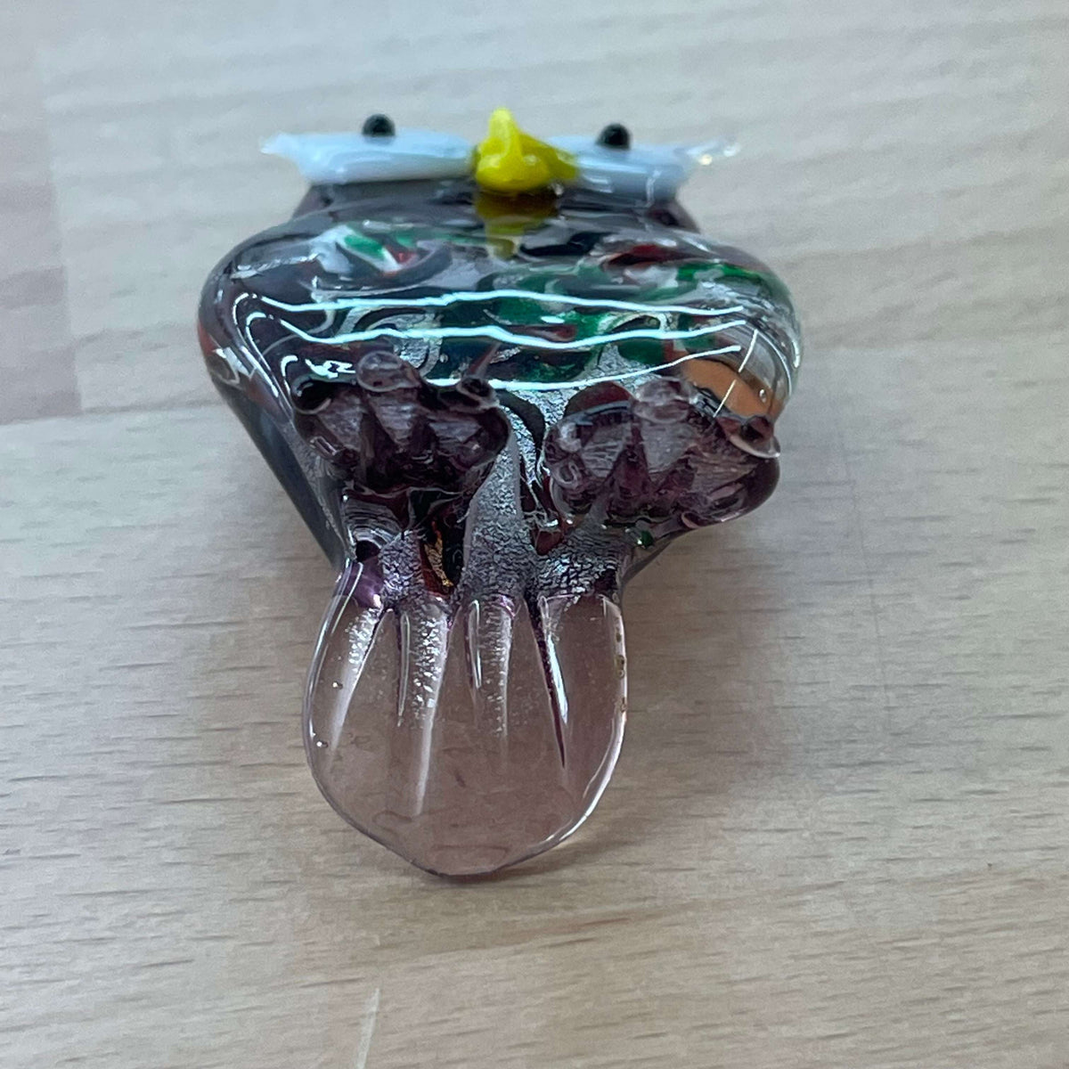 Purple art glass owl figurine — top view of the swirled glass
