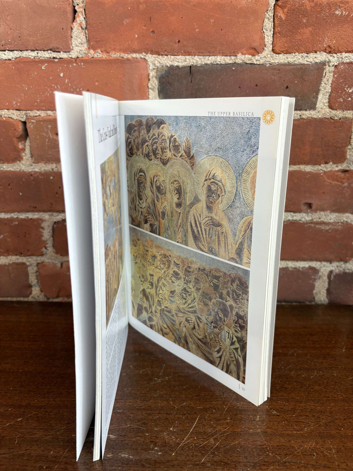 Assisi guidebook open to fresco and architecture pages