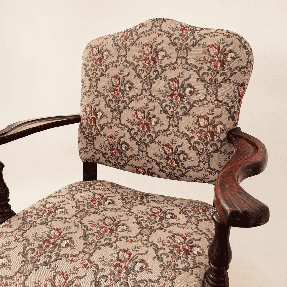 Antique Georgian Revival armchair showing the humped floral tapestry back