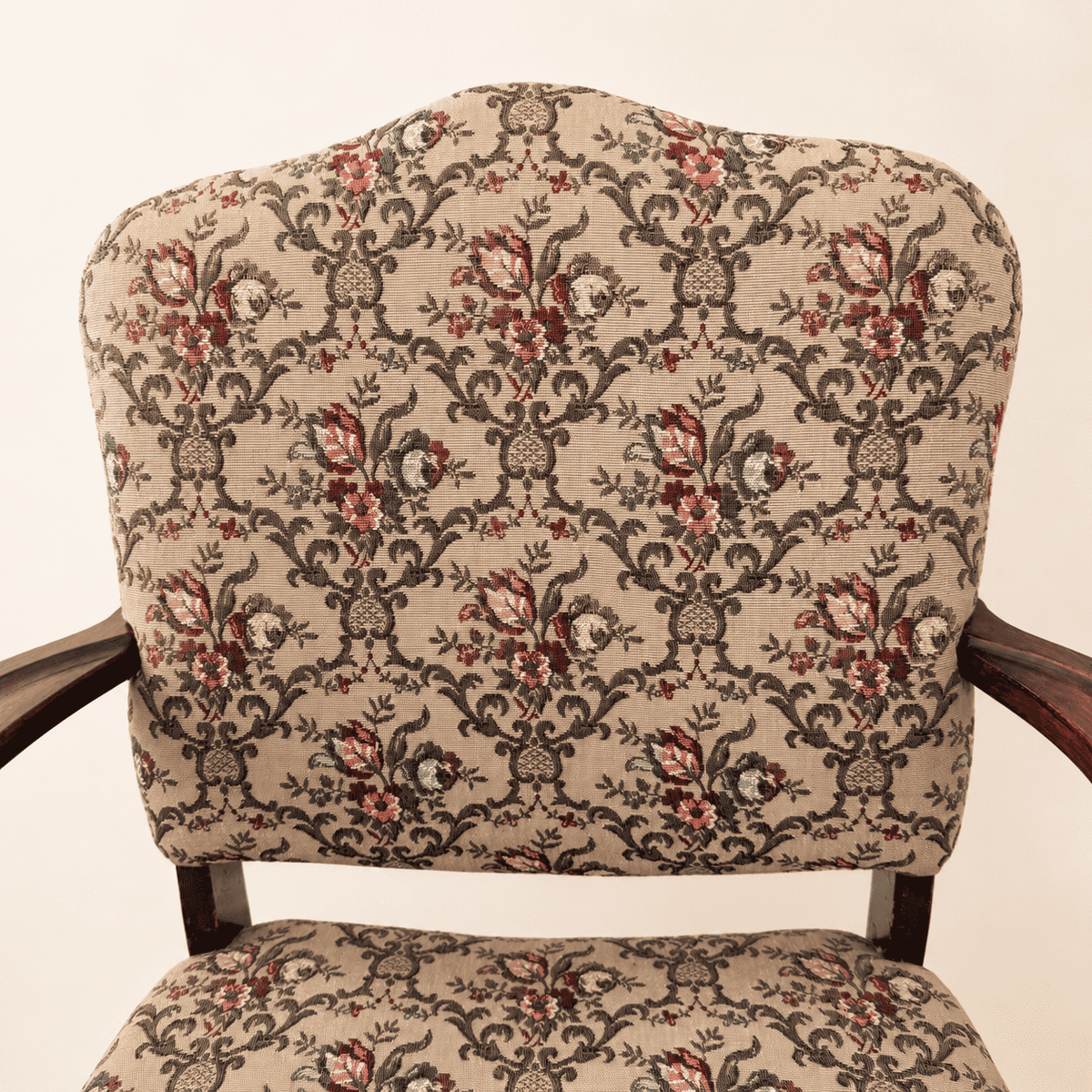 Carved scroll arm and turned baluster support on the Georgian Revival armchair