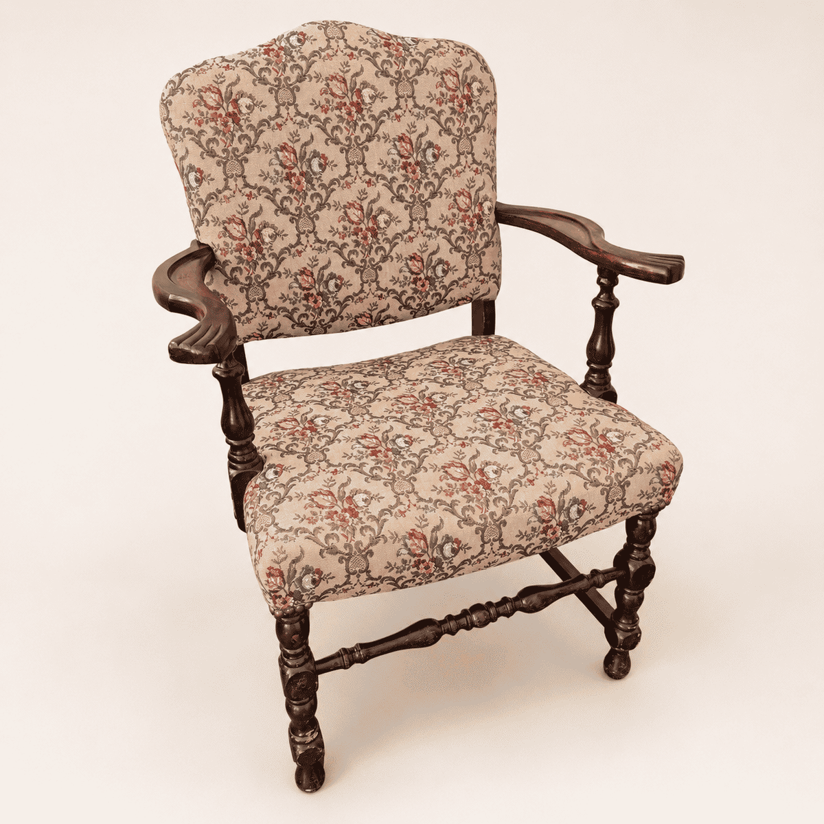 Antique Georgian Revival open armchair in floral tapestry with carved scroll arms, front view