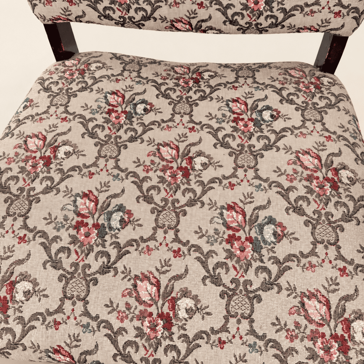 Side profile of the antique Georgian Revival tapestry armchair with turned legs