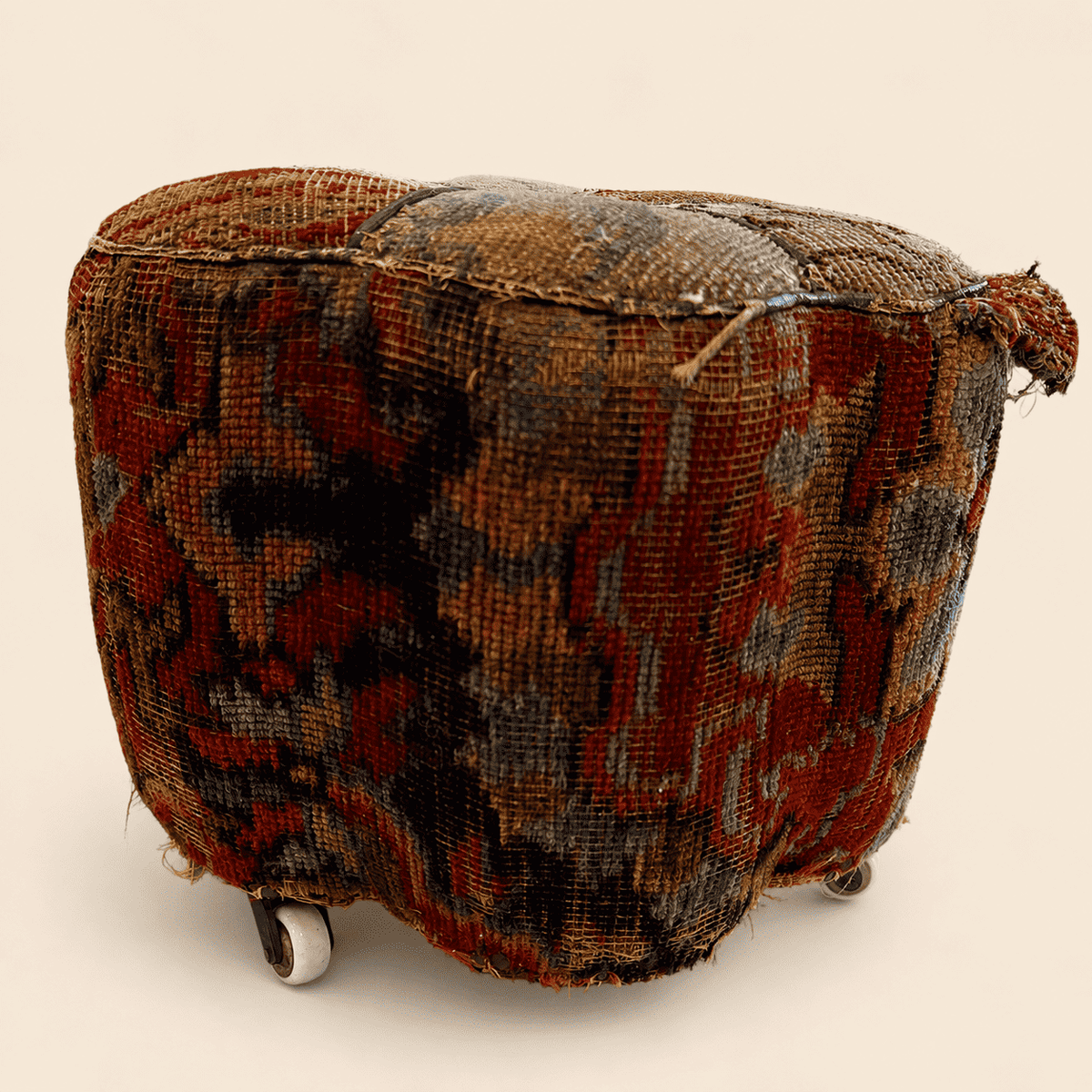 Antique Oriental carpet footstool, side profile view
