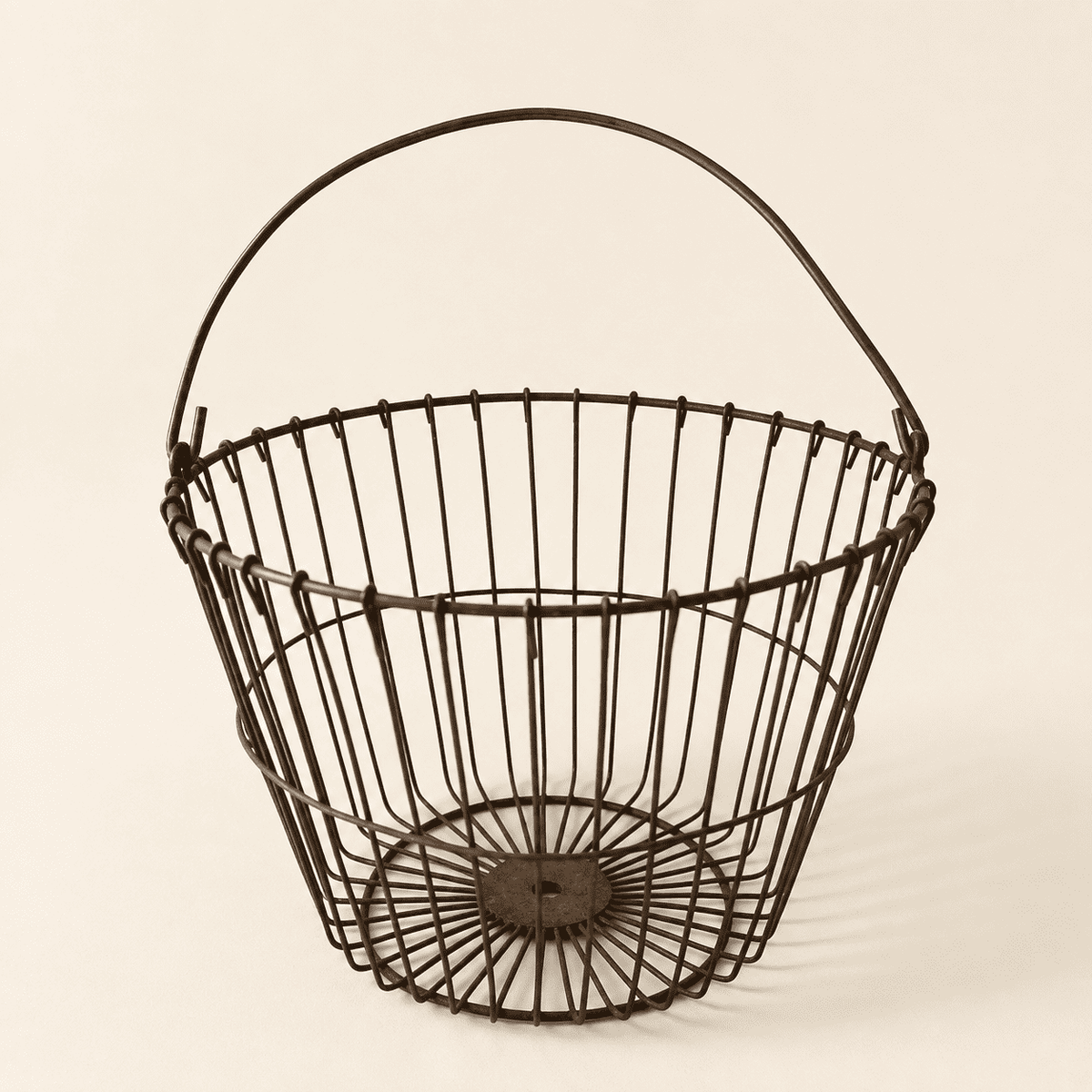 Antique wire egg gathering basket with bail handle, front view