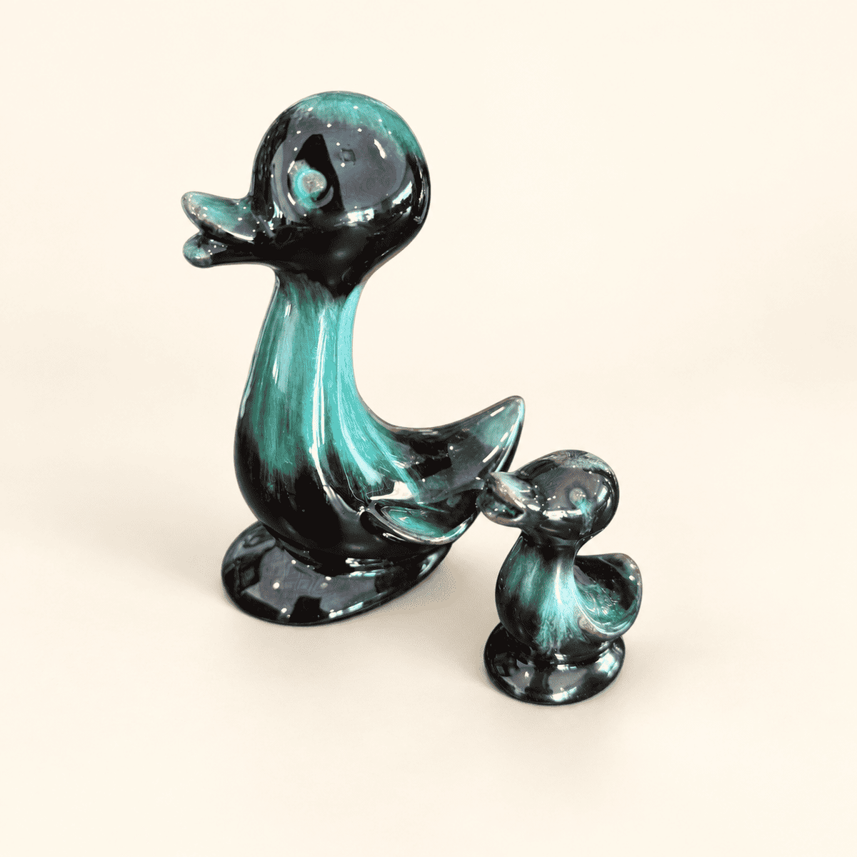 Pair of Blue Mountain Pottery ducks in teal-and-black drip glaze
