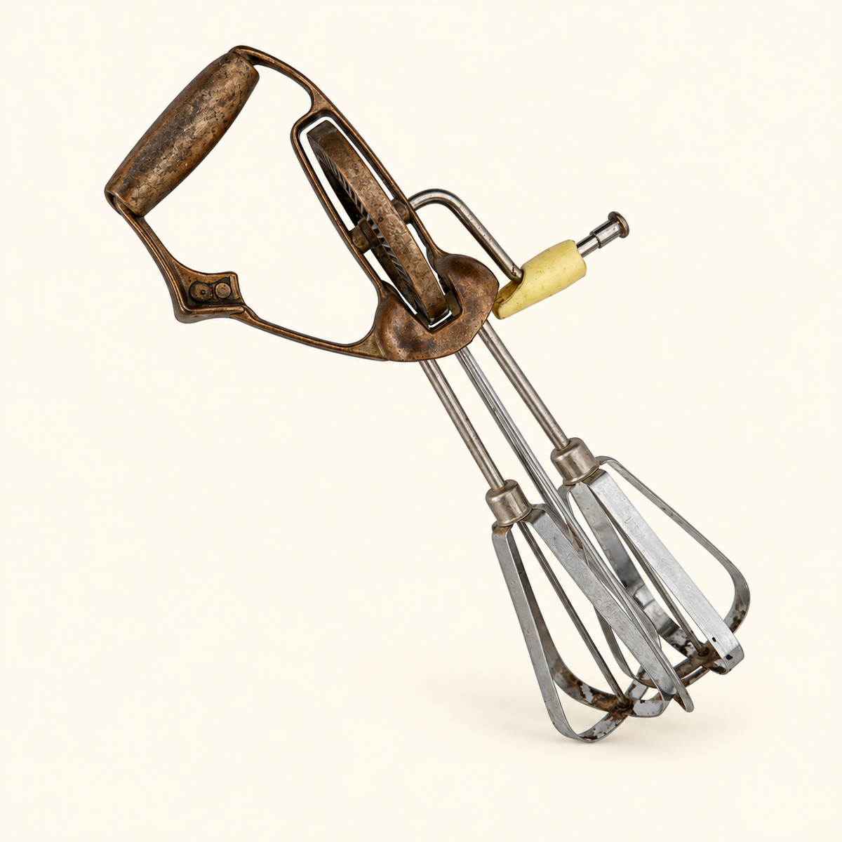 Three-quarter view of the whole beater, copper handle, gear, and stainless beaters