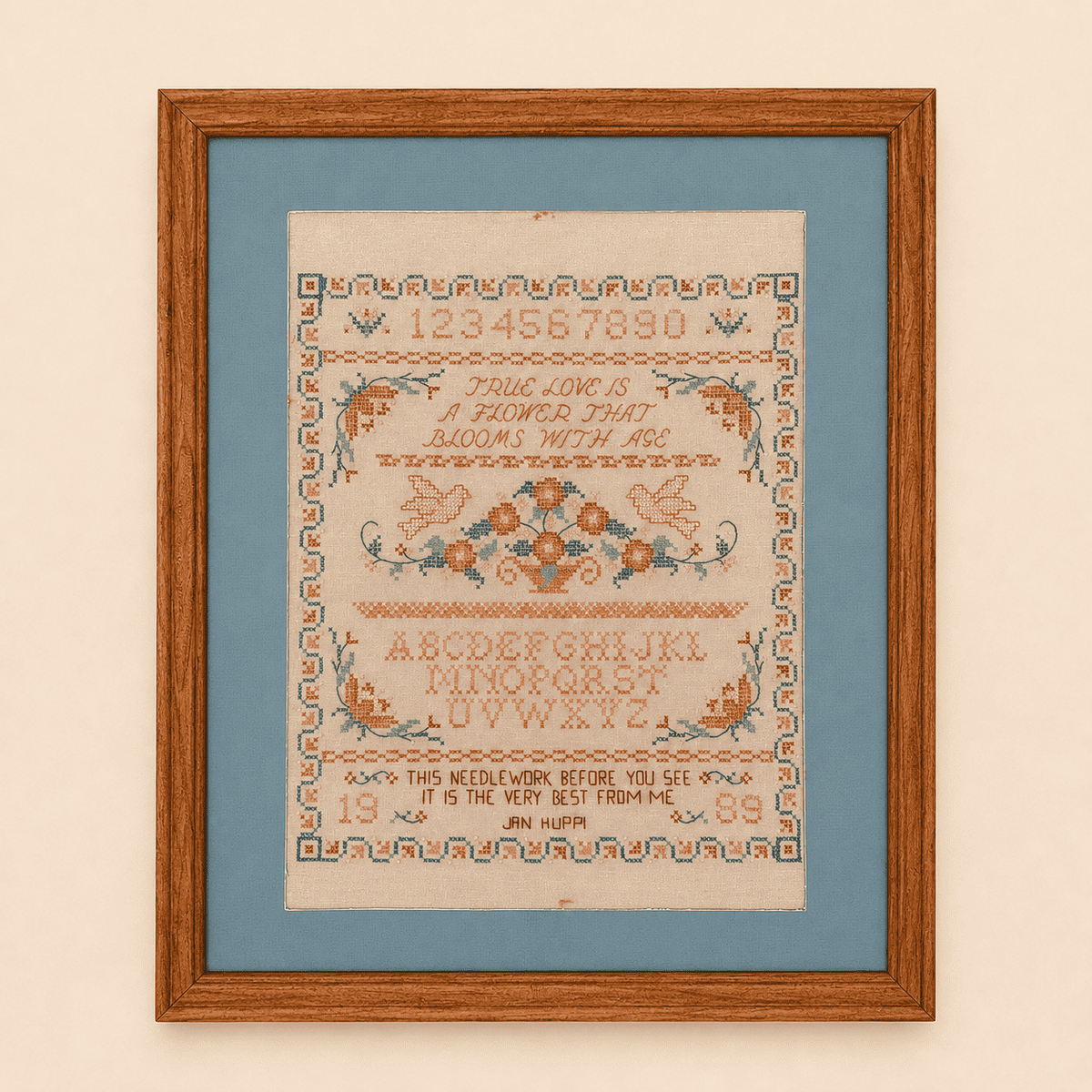 Framed cross stitch sampler with true love verse, doves, and floral basket