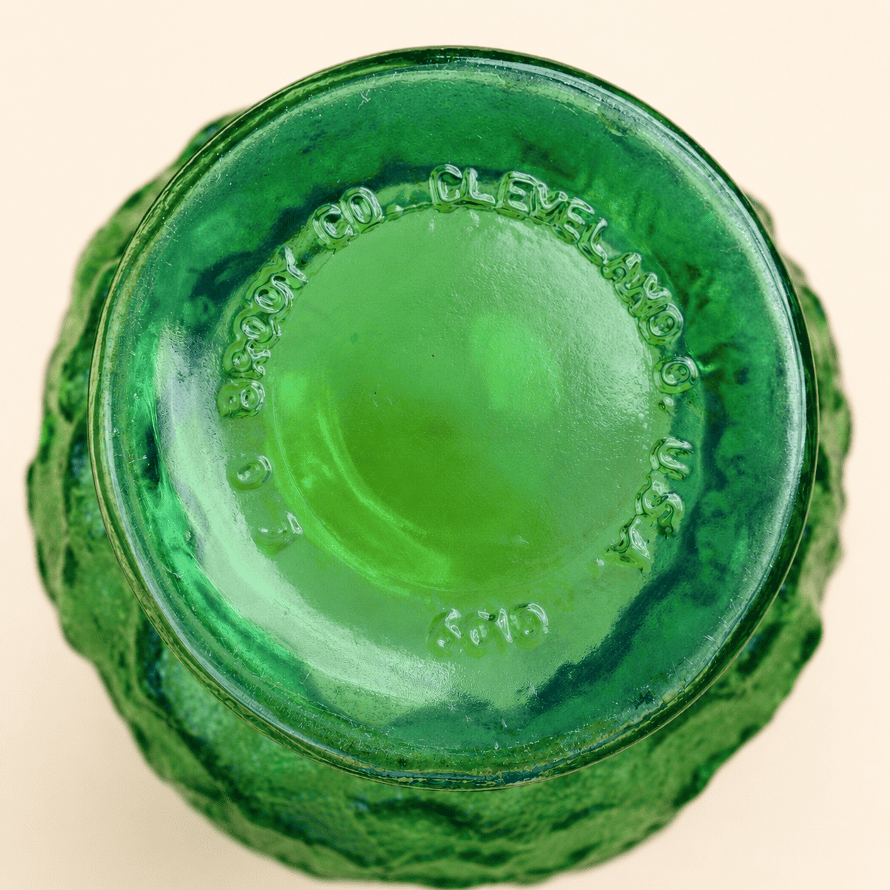 Base of E.O. Brody green crinkle glass vase showing Cleveland Ohio maker's mark