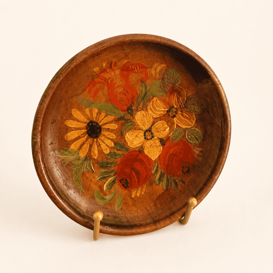 Angled view of hand-painted tole-style floral wood plate