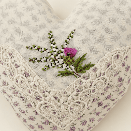 Detail of hand-embroidered Scottish thistle and heather on heart pillow
