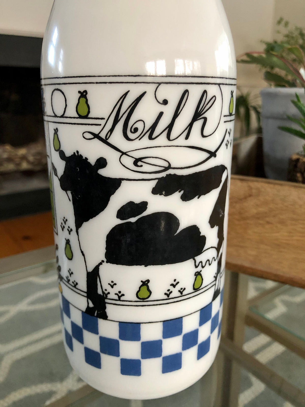 Close-up of the cow and script Milk lettering on the Alan Wood milk bottle