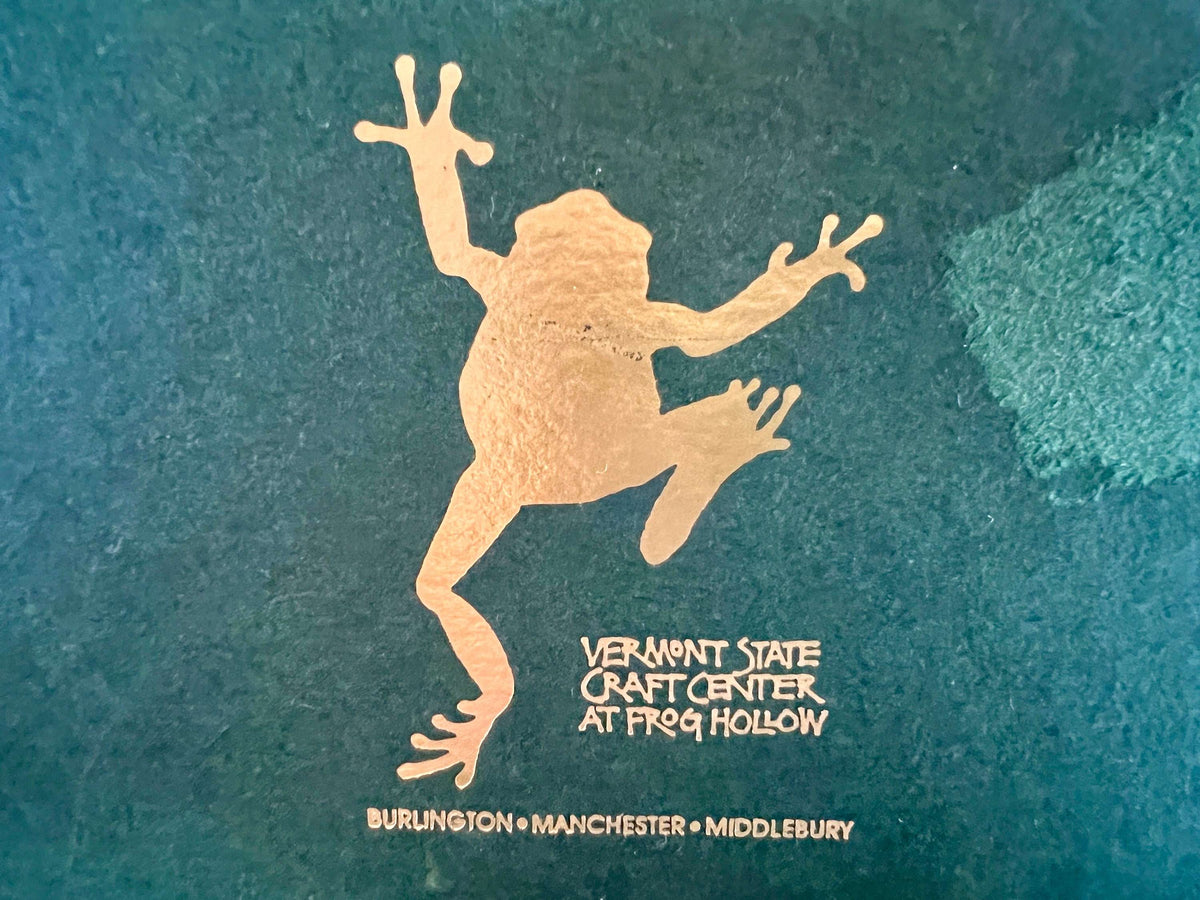 Handmade ceramic Christmas ornament of a bear in a green scarf holding a 2005 star, from Vermont — detail view