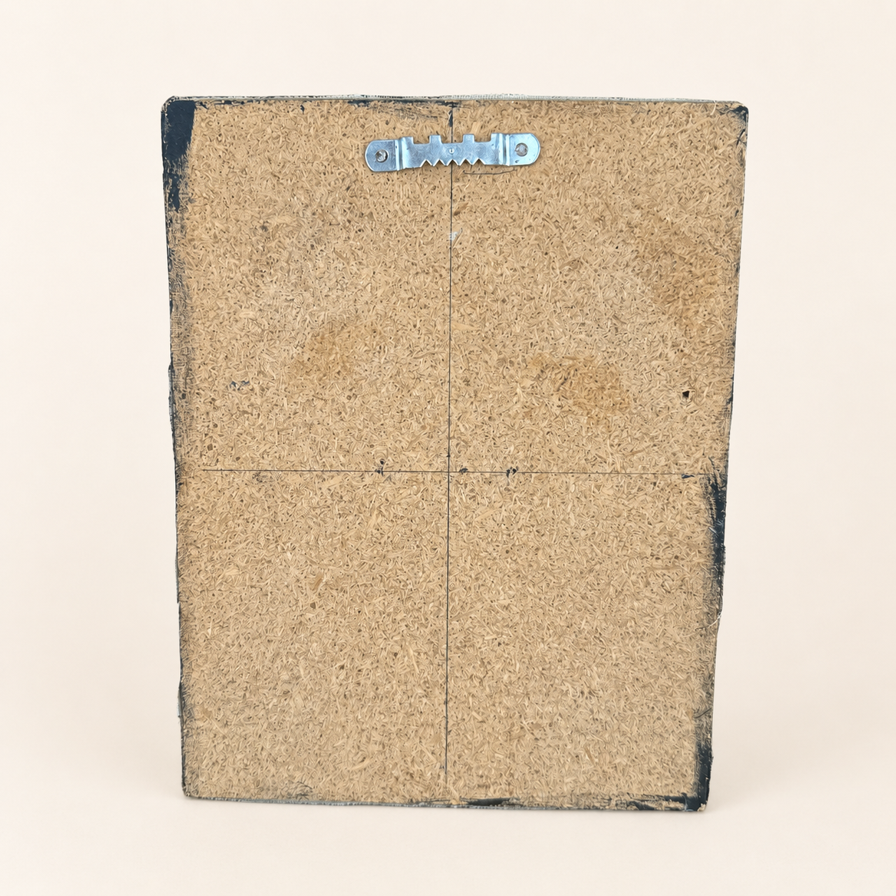 Back of canvas board painting showing sawtooth hanger