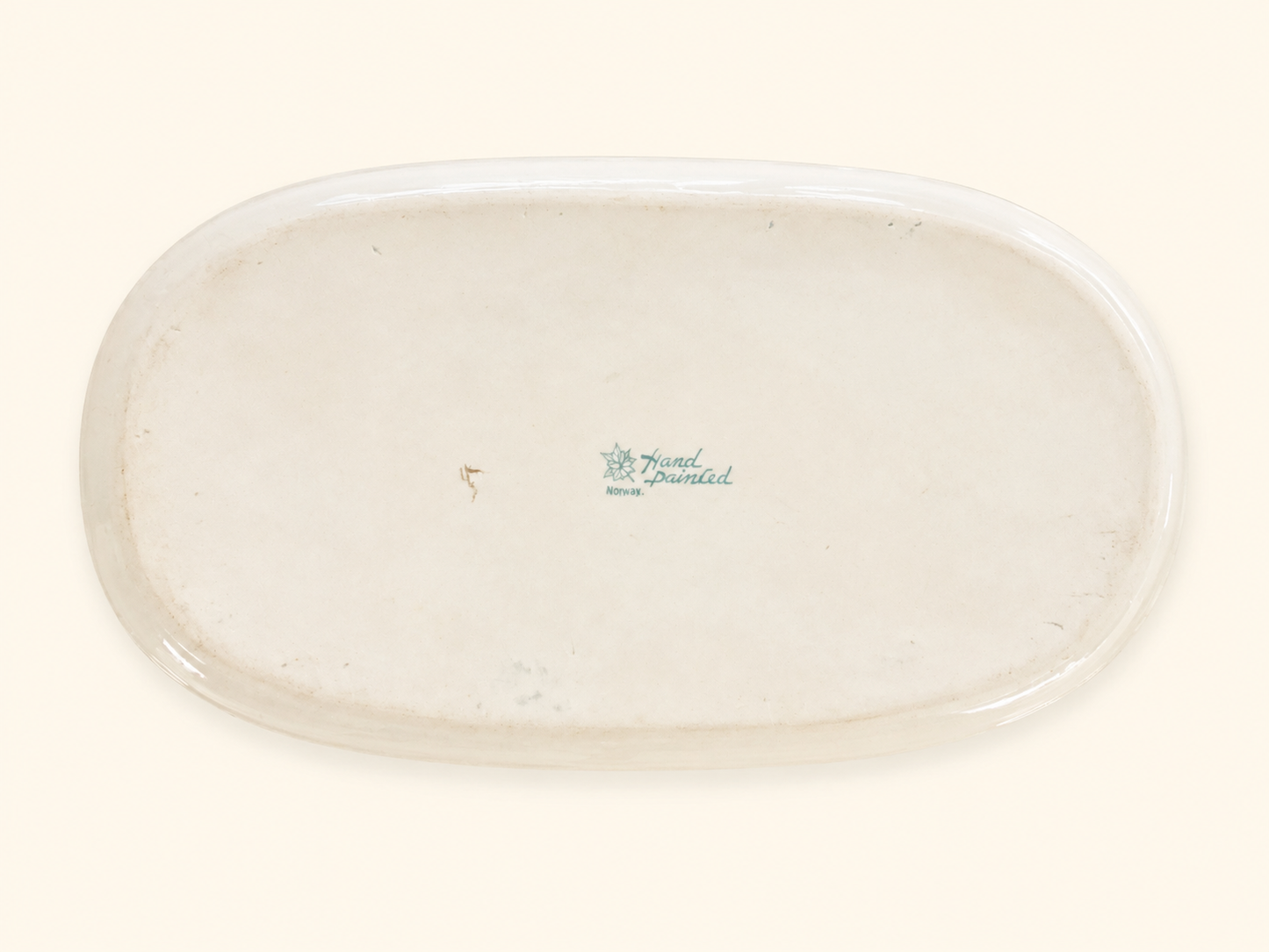 Green maple leaf Nippon backstamp on the underside of an antique porcelain dish