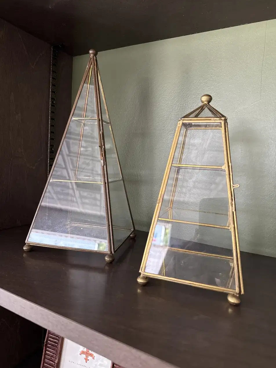 Pair of brass and glass obelisk display cases on mirrored bases, front view
