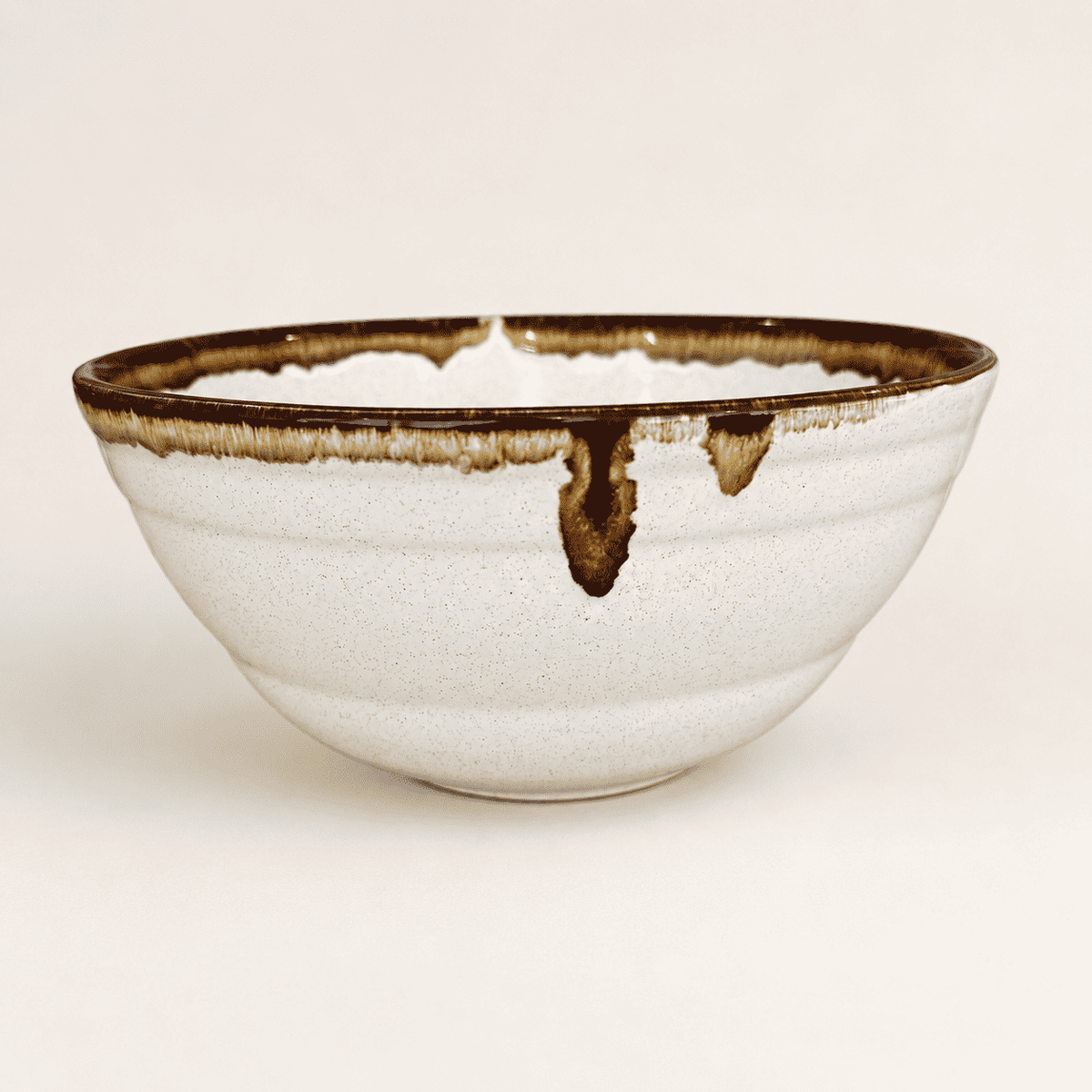 Pfaltzgraff Country Casual stoneware bowl with brown drip rim, side view