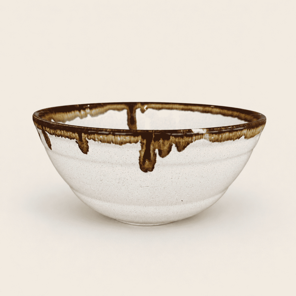 Detail of brown and caramel drip glaze on bowl rim