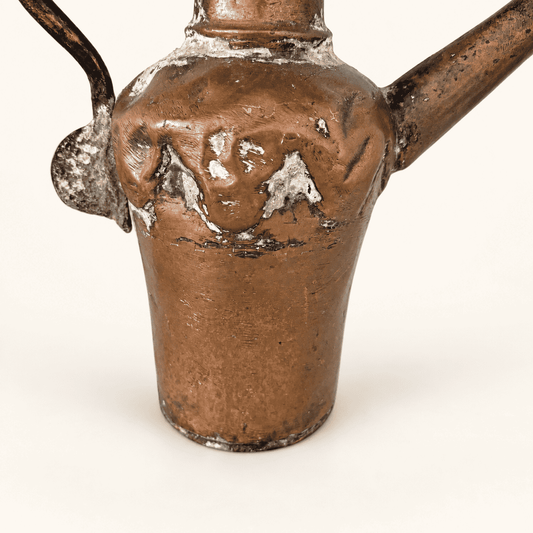 Hammered copper body and the dovetailed spout join, worn tin wash and hammer marks in close detail