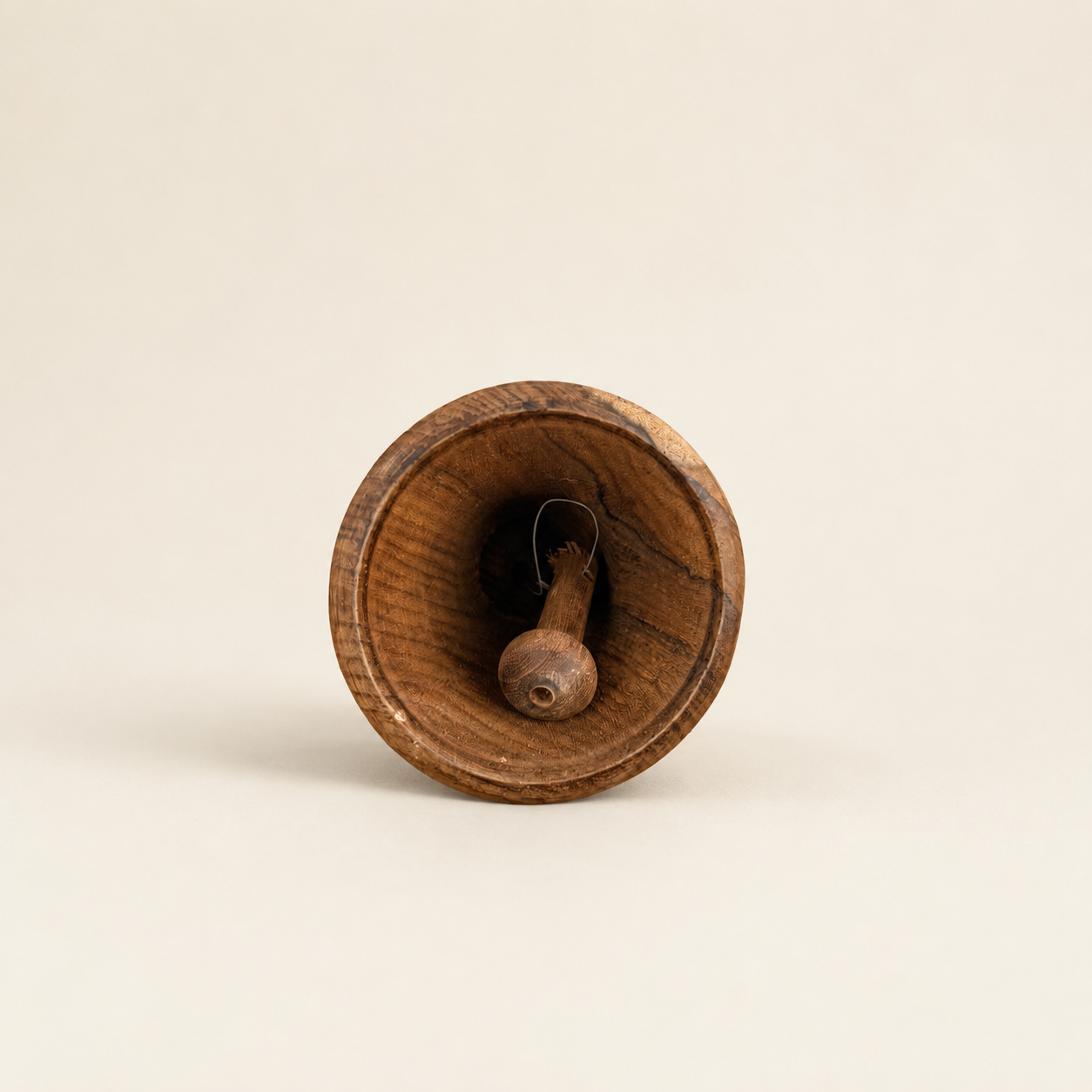 Interior of wooden hand bell showing wooden clapper