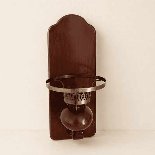 Front view of colonial wood wall sconce with pierced brass candle cup