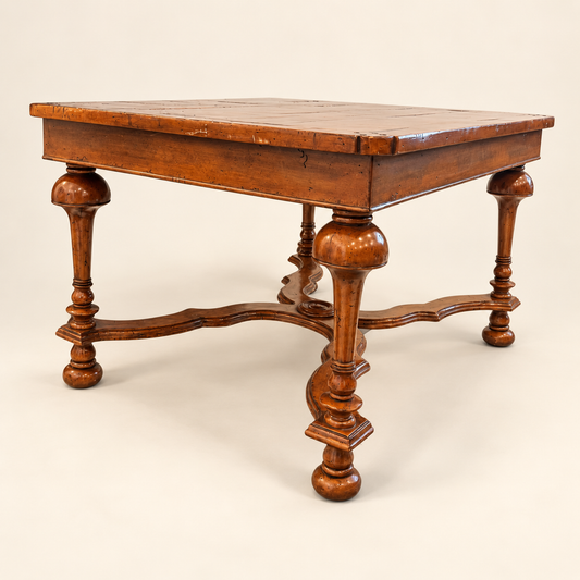 Side view of walnut coffee table showing inverted-cup legs and X-stretcher