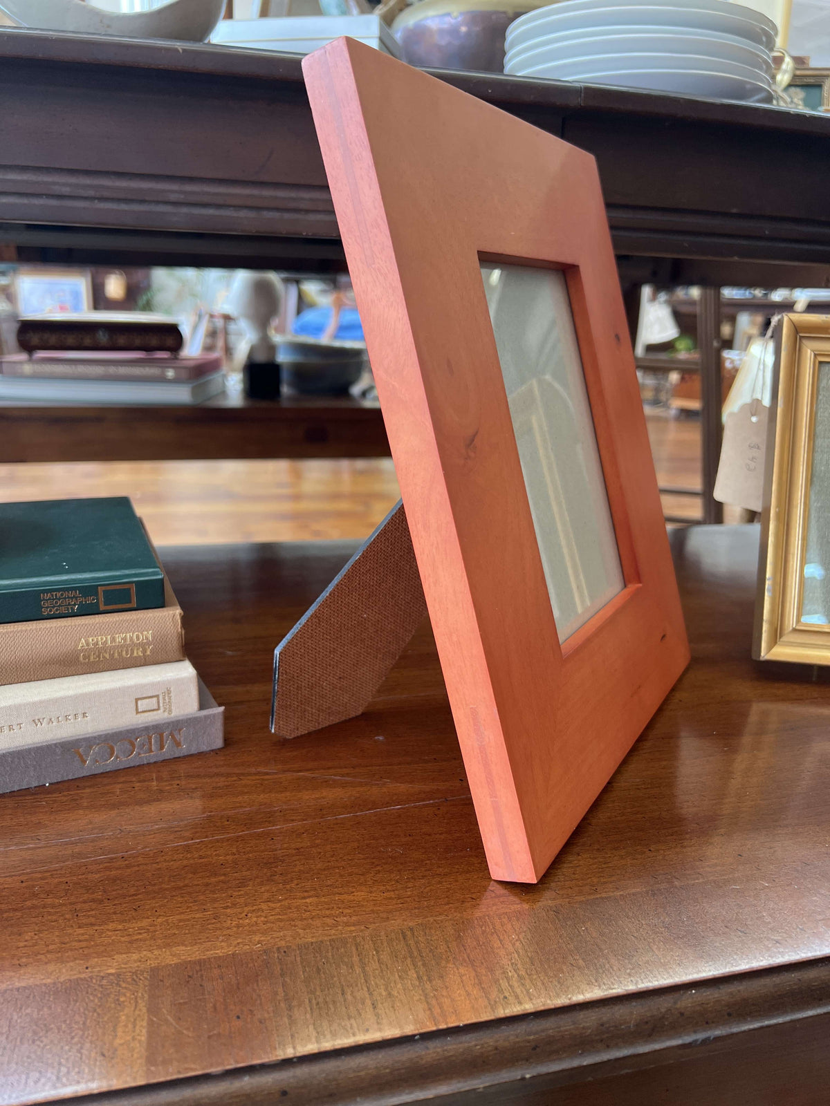 Wide wood picture frame — side view on its easel stand