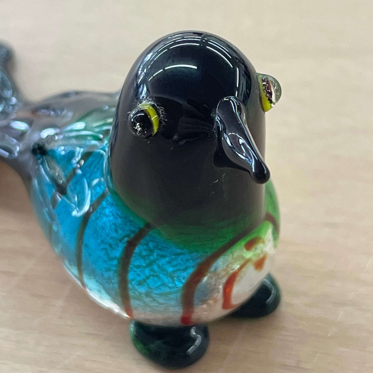 Art glass bird figurine — front view, green and blue swirled body