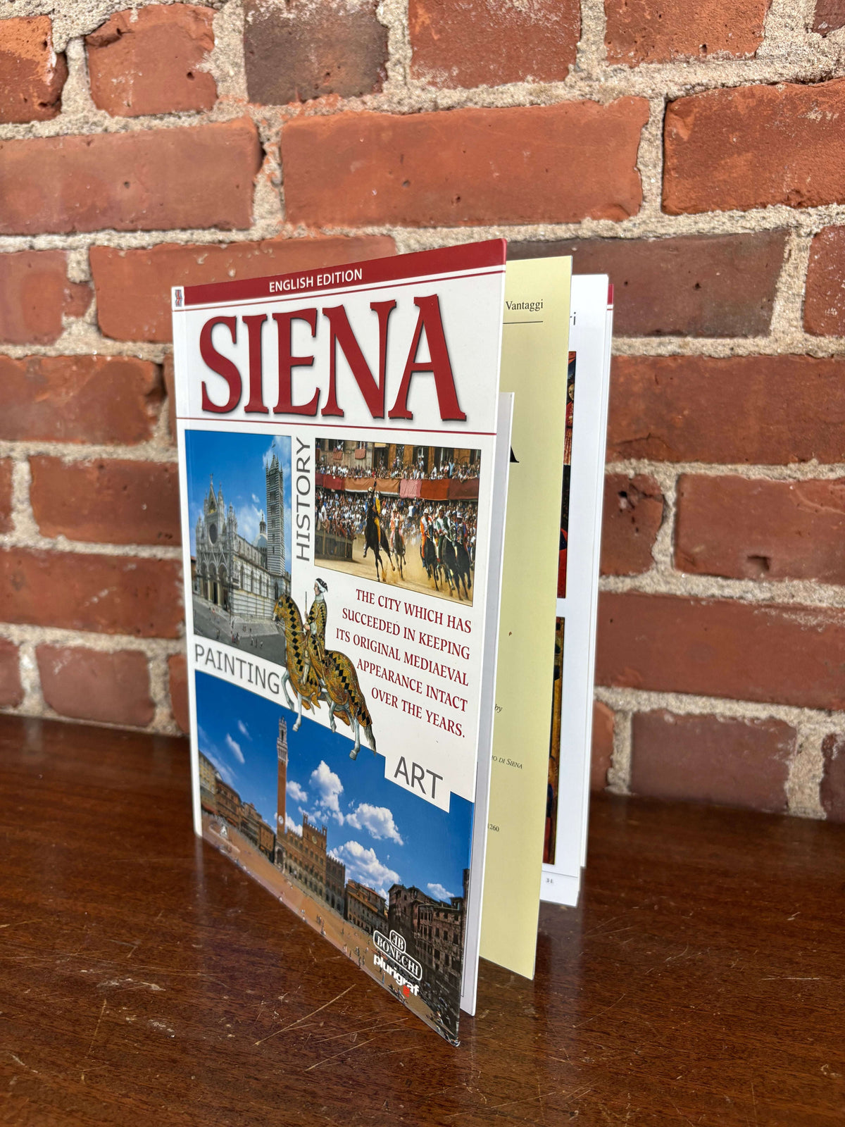 Siena guidebook open to city and art plates