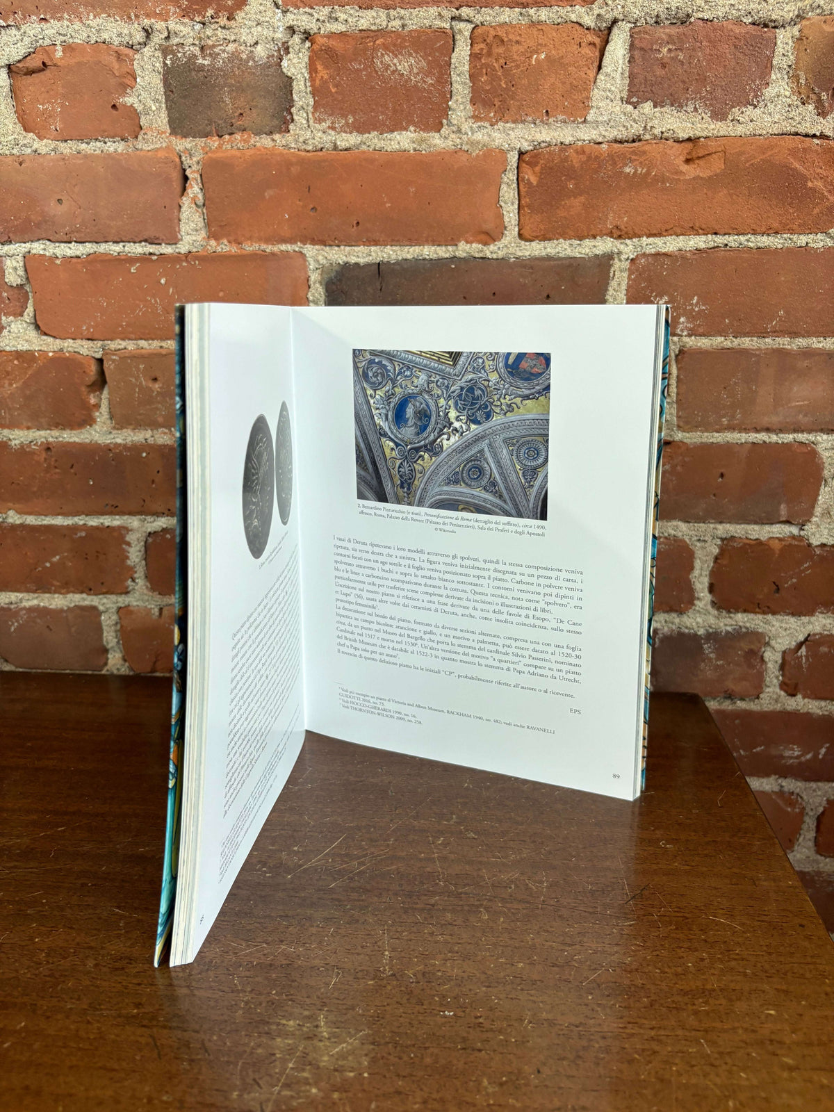 Back to Deruta book open showing a decorated ceramic plate
