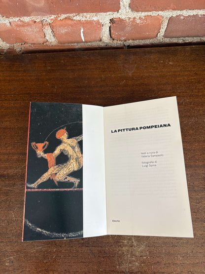 La Pittura Pompeiana book open to fresco plate pages
