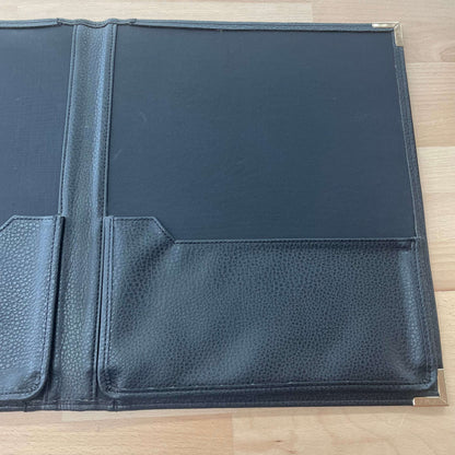 Black leather portfolio — open to interior pockets and notepad slot