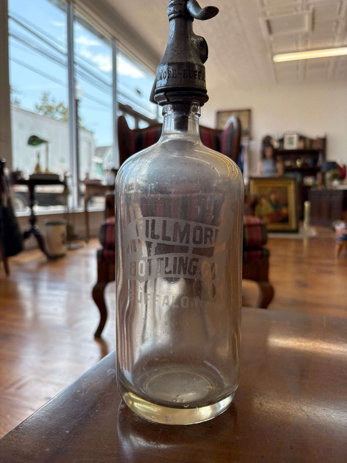 Fillmore Bottling Co. embossed glass soda bottle with a metal tap, Buffalo NY