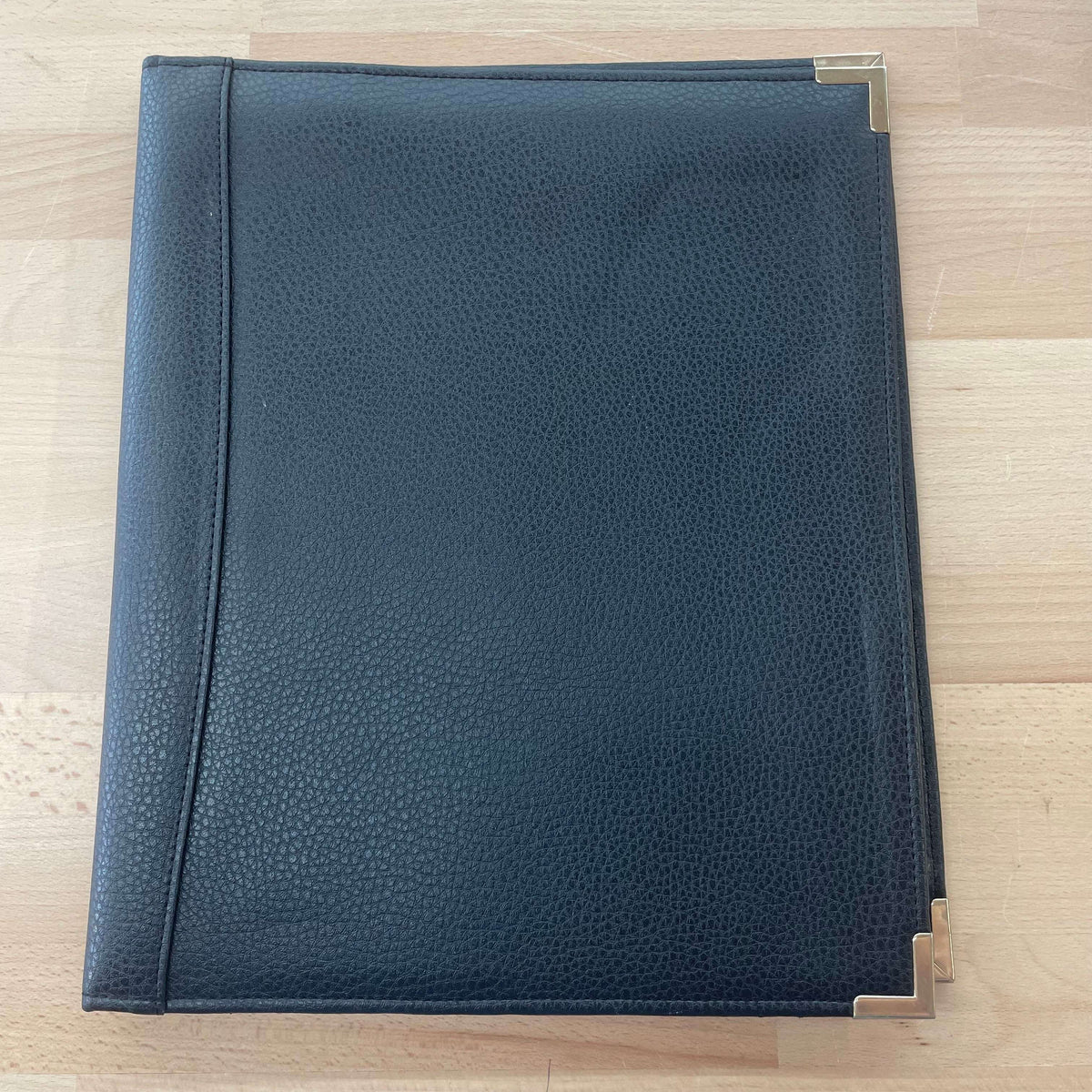 Black leather portfolio — closed view