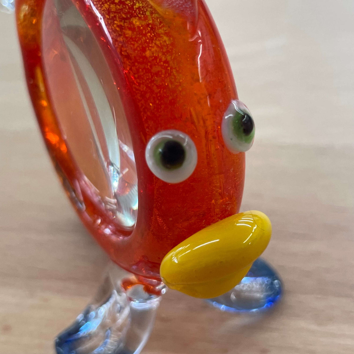 Art glass fish magnifier — angled view through the magnifying lens