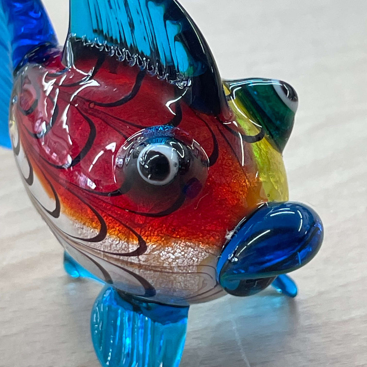 Art glass rainbow fish — front three-quarter view, patterned body
