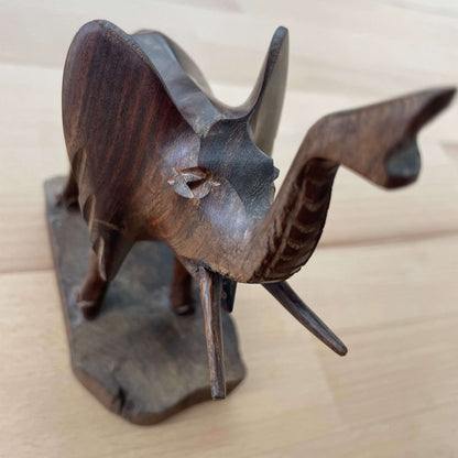 Carved wooden elephant — front three-quarter view showing ears and tusks