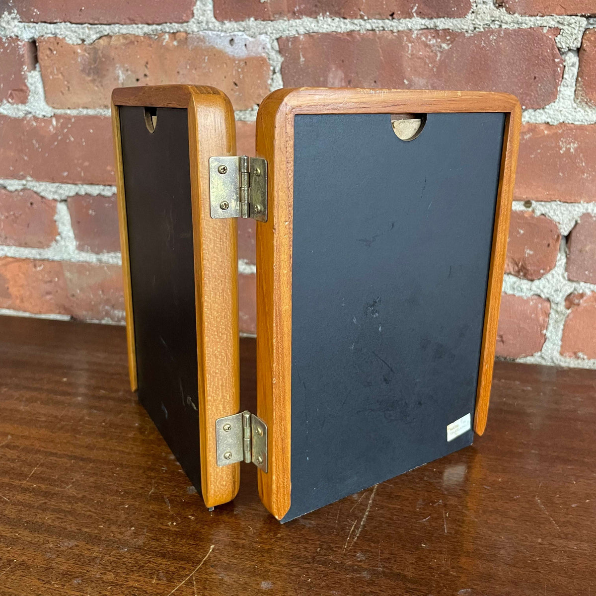 Hinged double wood picture frame — back view showing black backing and center hinge