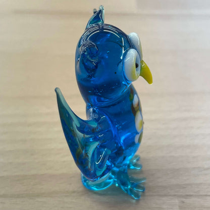 Blue art glass owl figurine — side profile, wings raised