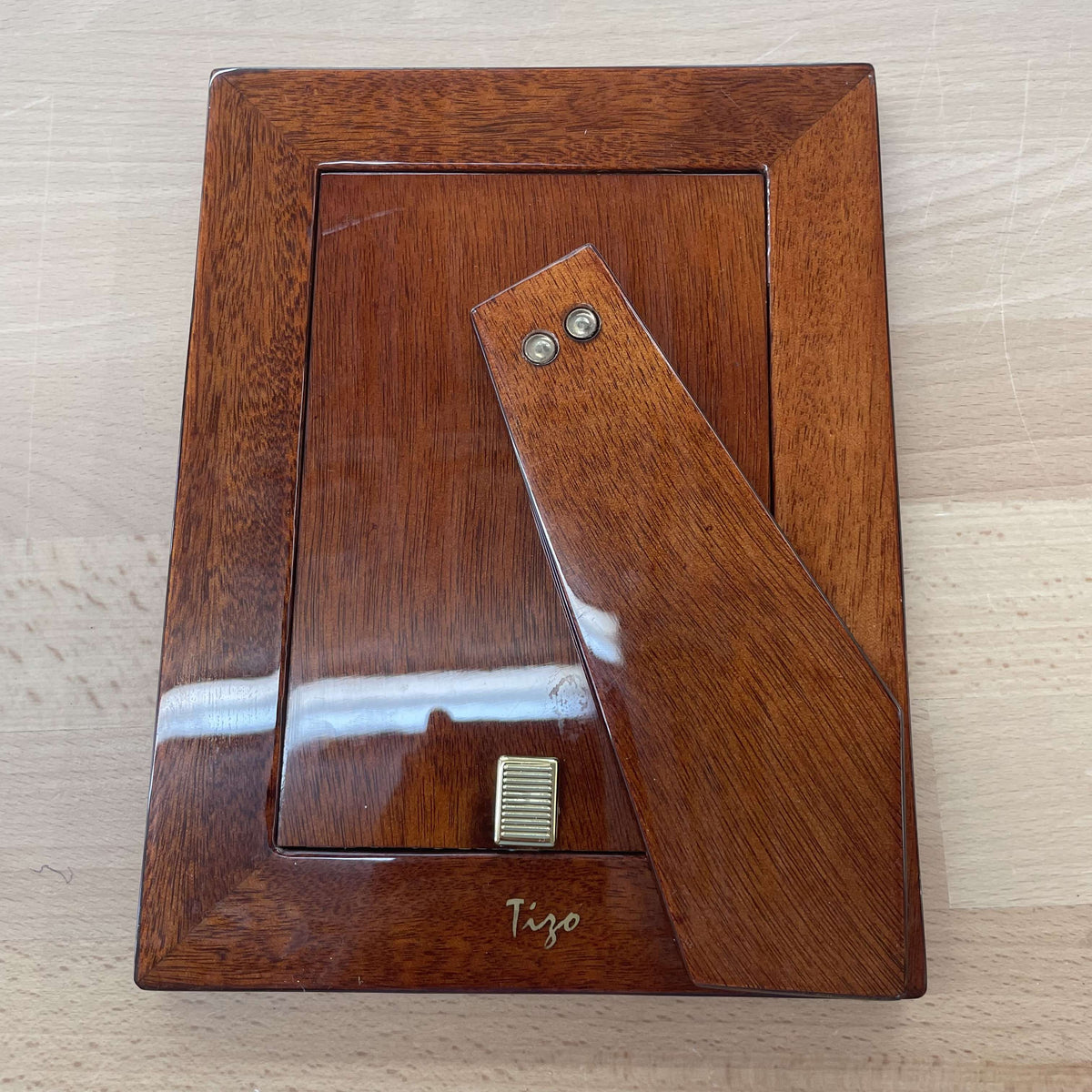 Tizo tortoiseshell lacquer picture frame — side profile on its easel stand
