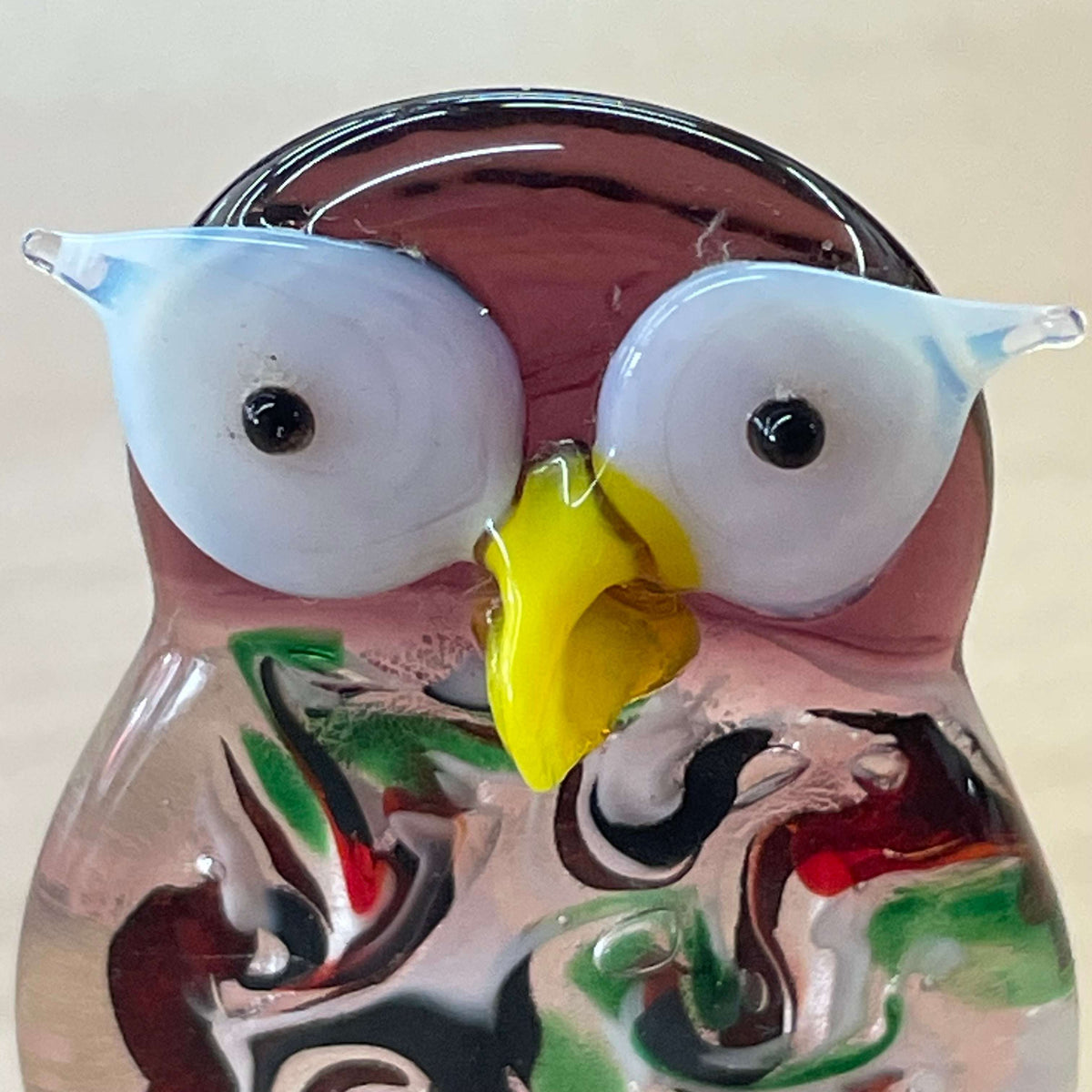 Purple art glass owl figurine — front view, yellow beak and wide eyes