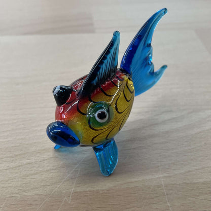 Art glass rainbow fish figurine with a red and yellow body and tall blue fins