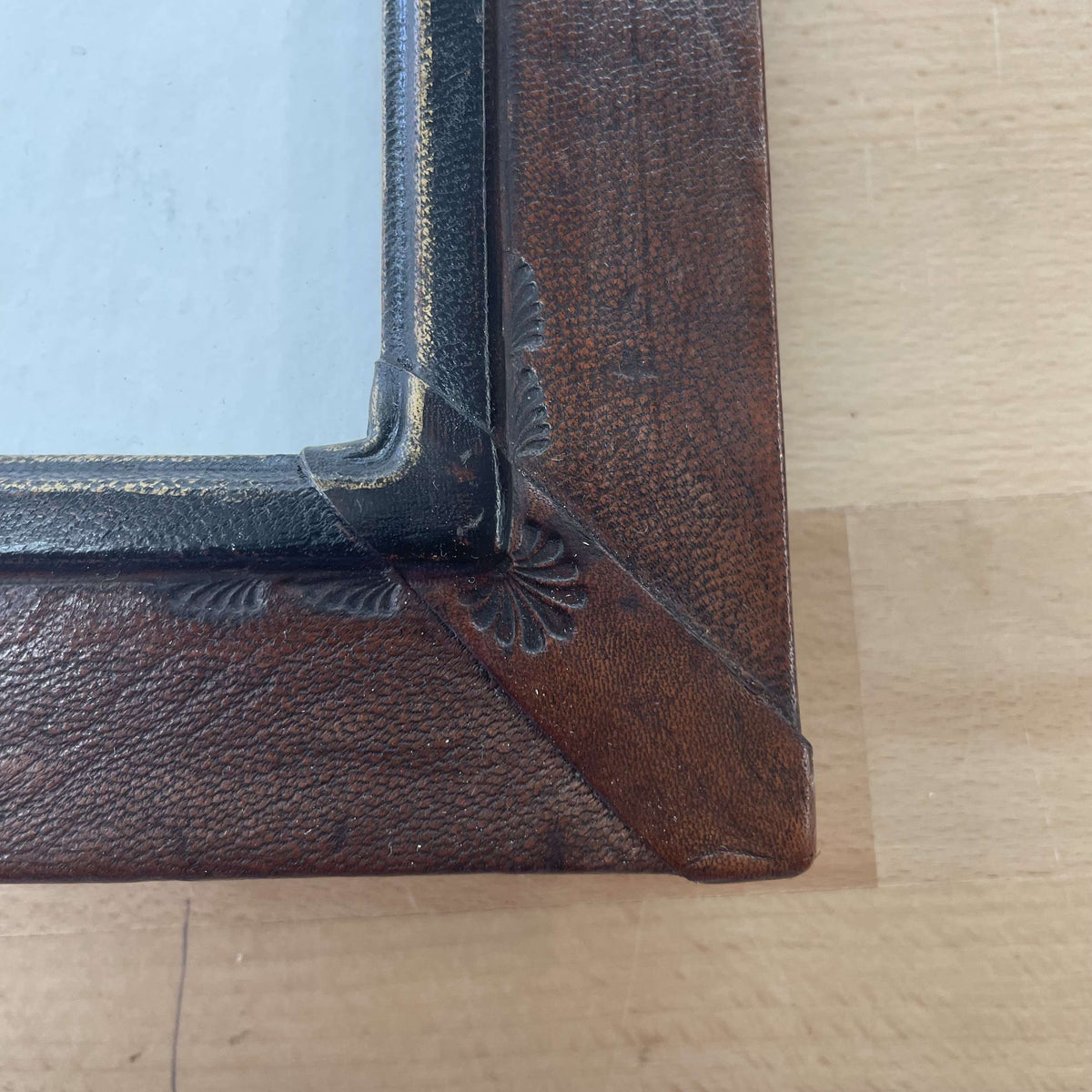 Embellished leather frame corner detail