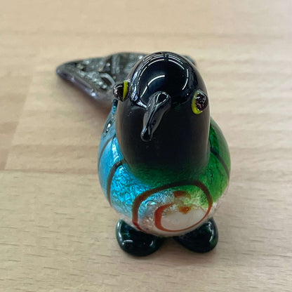 Art glass bird figurine — three-quarter view with yellow glass eyes