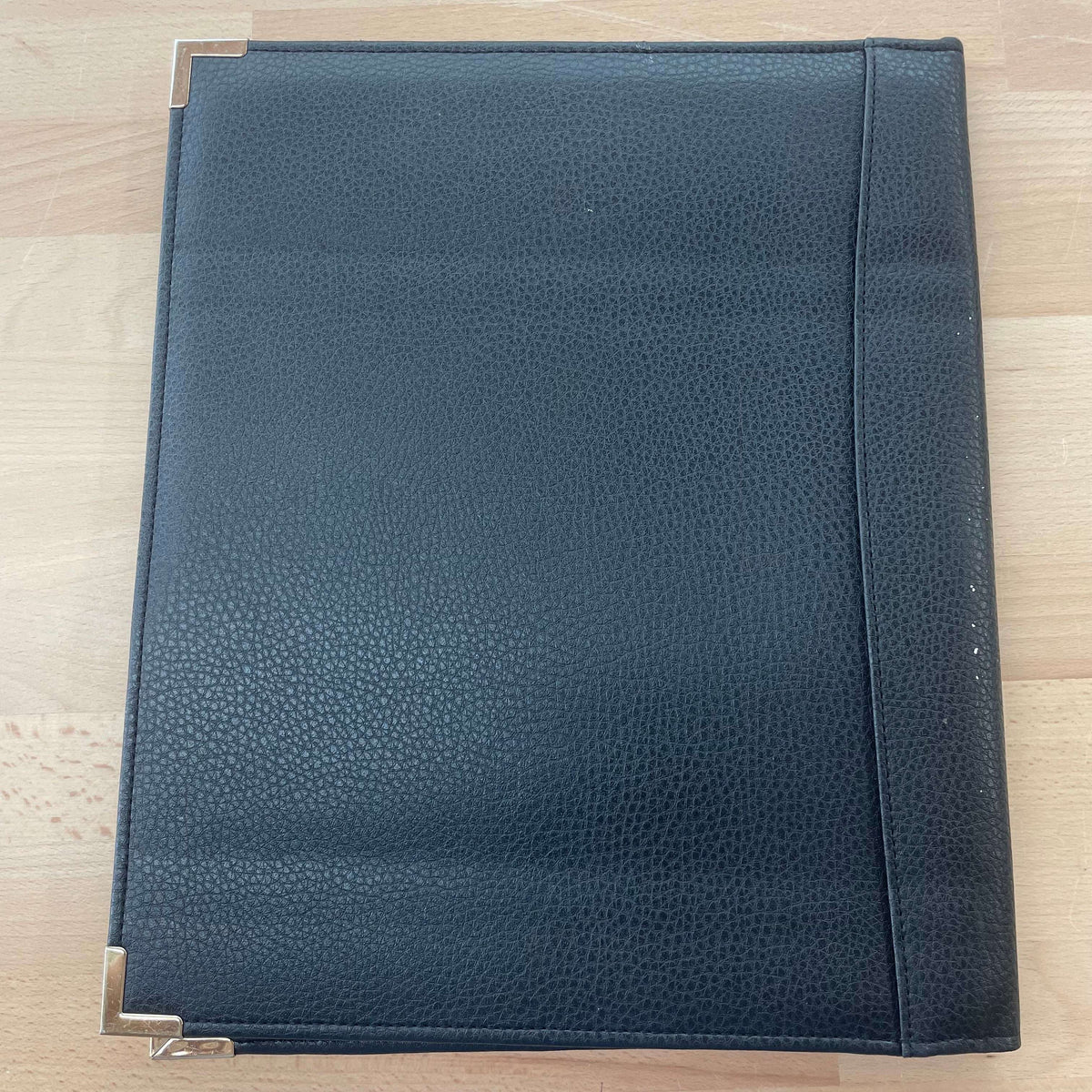 Black leather portfolio — front cover detail