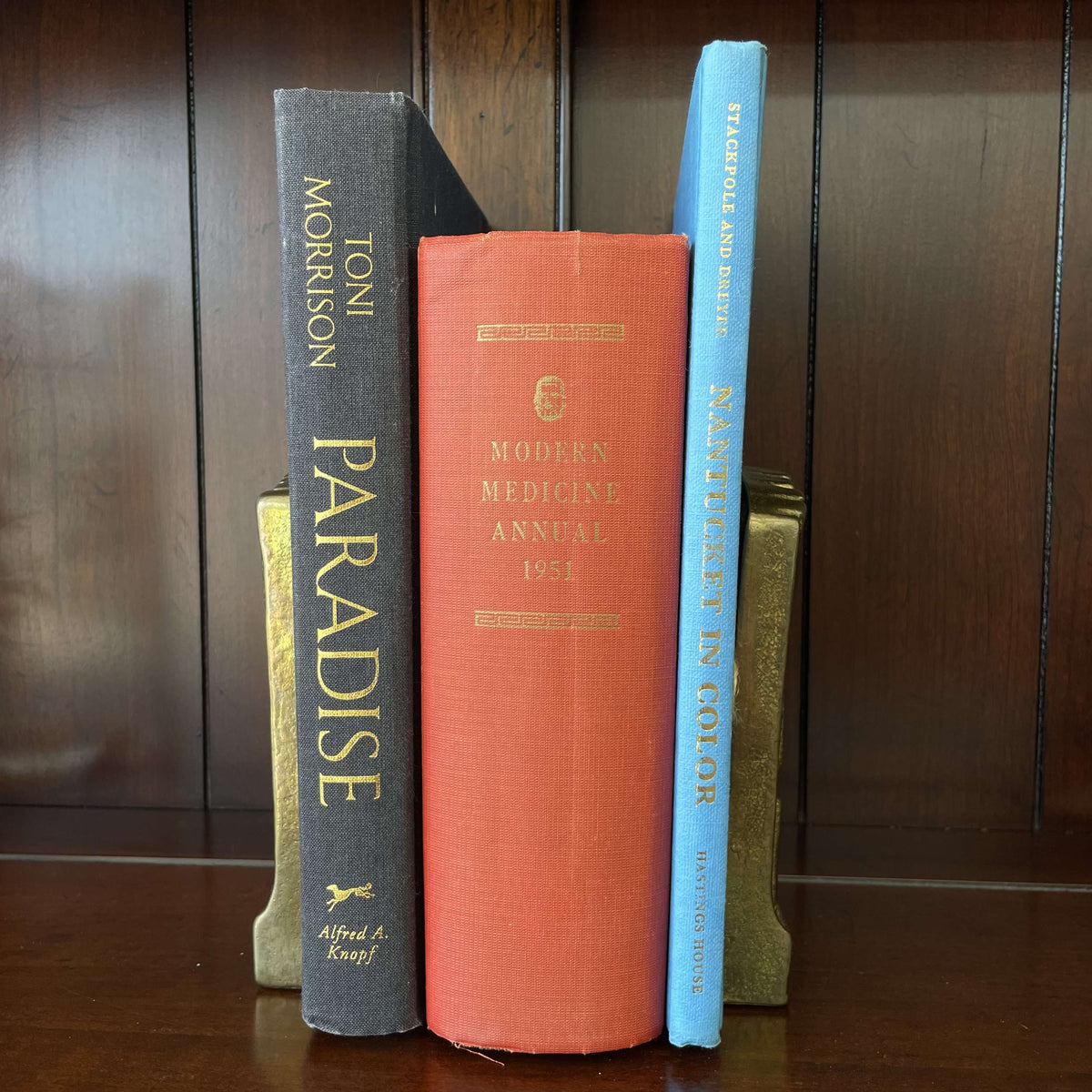 Vintage hardcover books on a shelf including Nantucket in Color