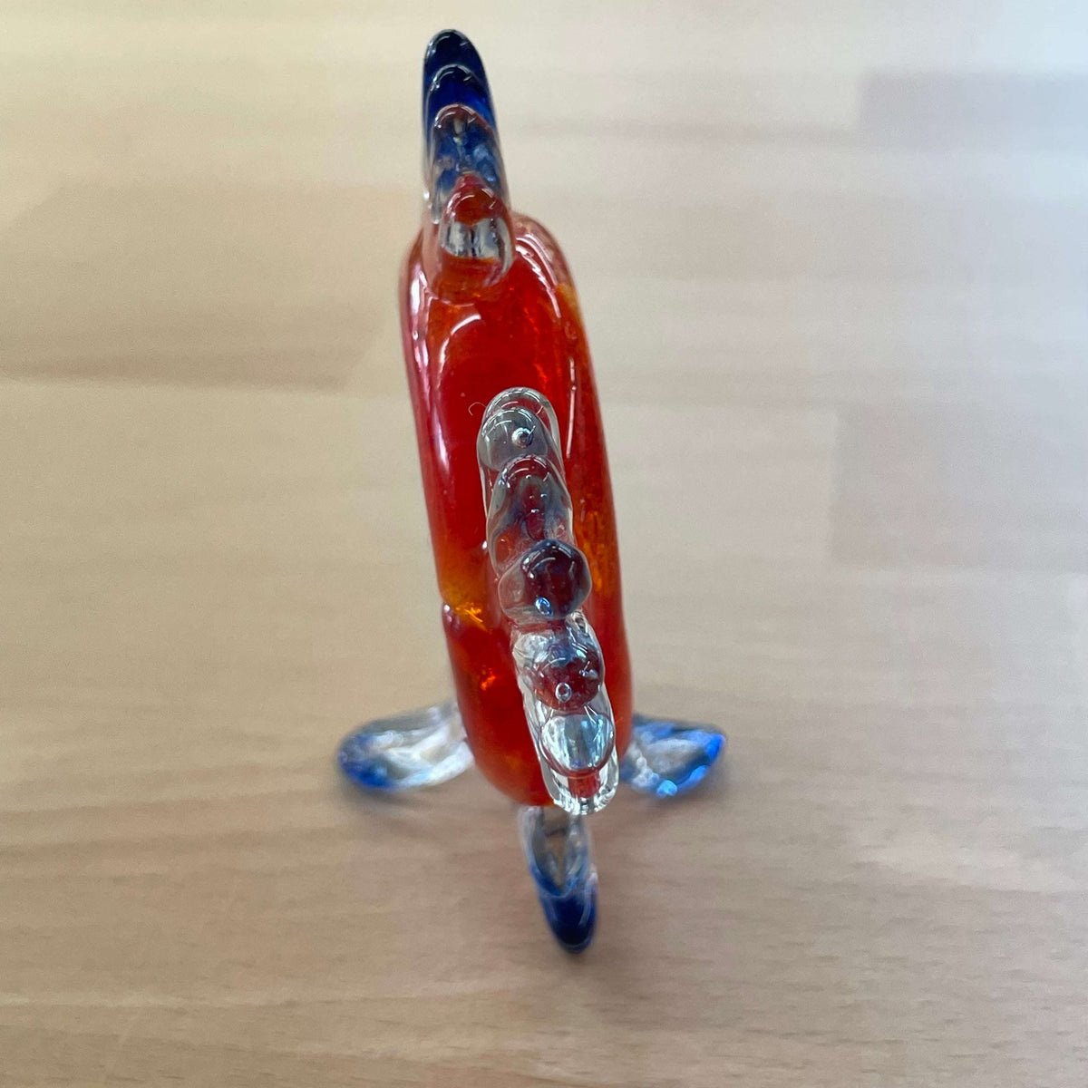 Art glass fish magnifier — profile on its blue glass fins