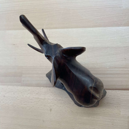 Carved wooden elephant — overhead view of trunk and tusks